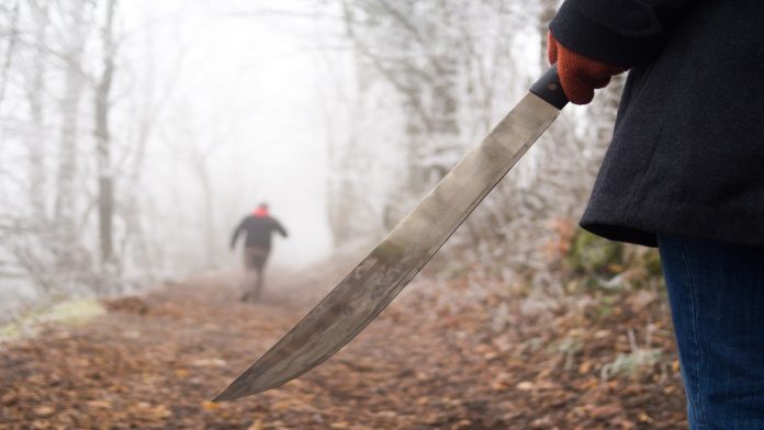 Woman with machete chasing man