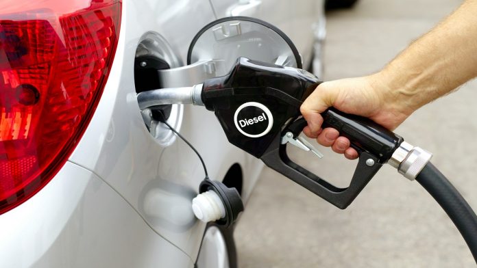 Man filling car with diesel pump