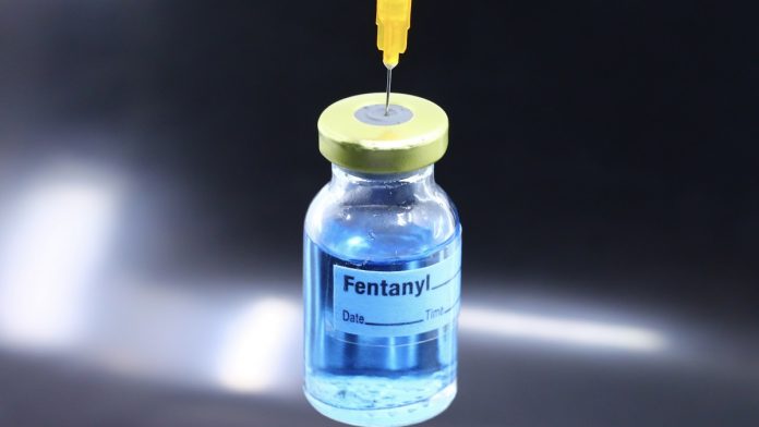 Fentanyl narcotic and a syringe - overdose death concept