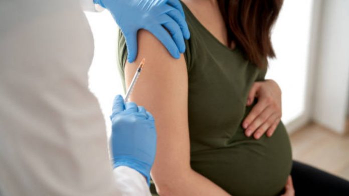 Midsection Of Female Doctor Examining Patient In Hospital